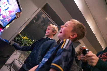 Children laughing in front of a television trying to get the CandyCam interface to work