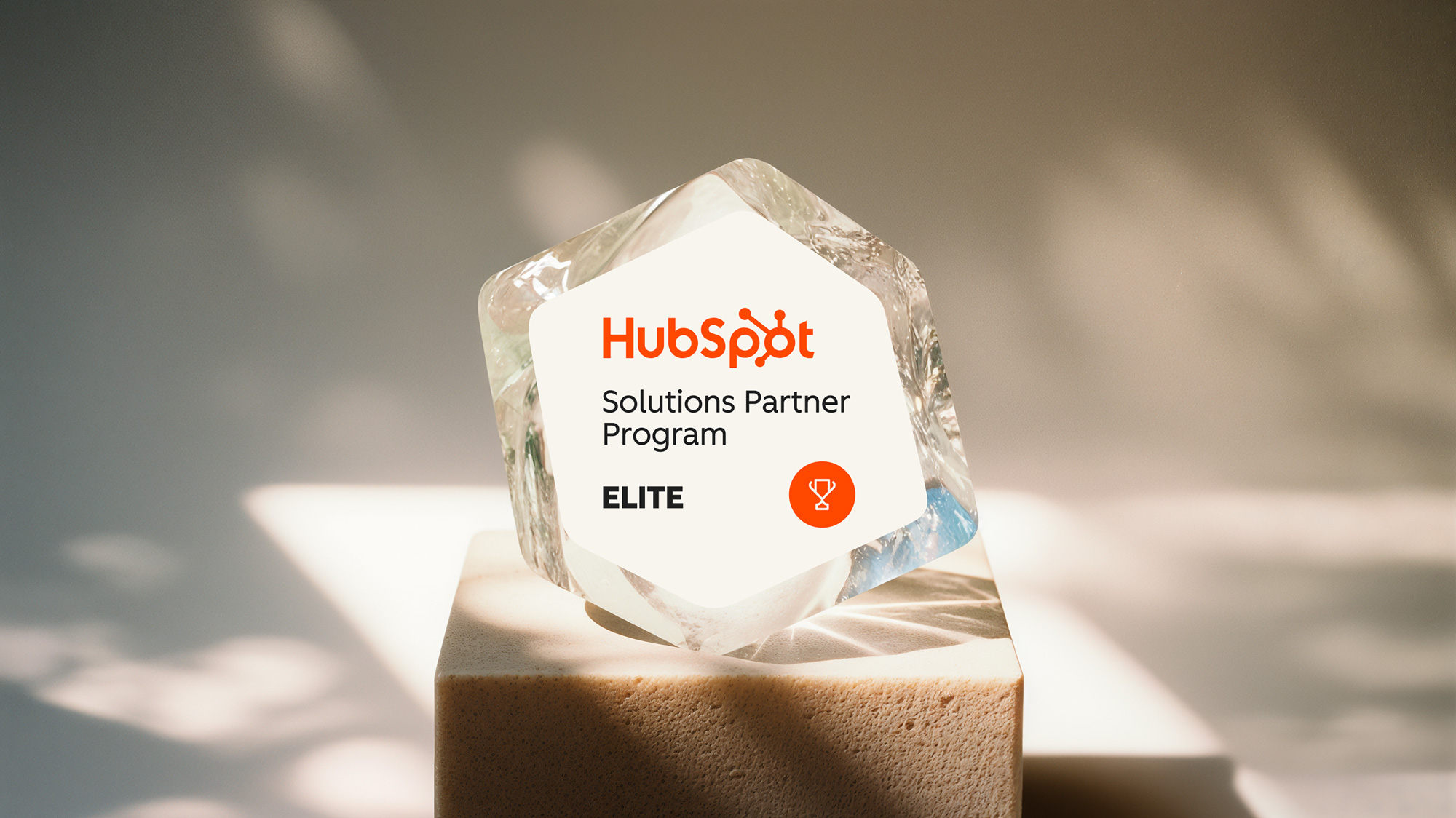 A sign on a crystal rock saying we are a hubspot elite partner