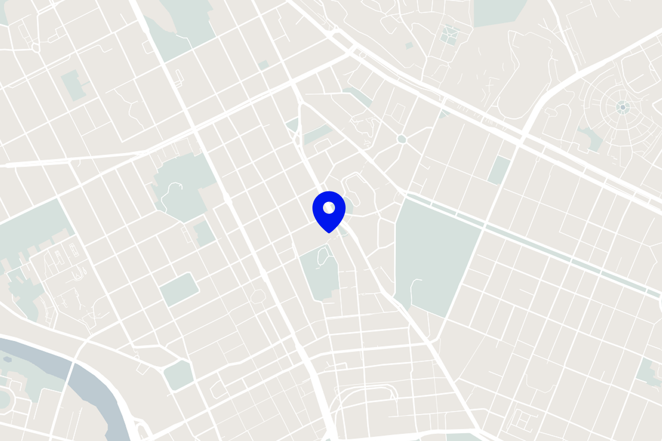 Map showing a grid layout of streets with a blue location marker in the center.