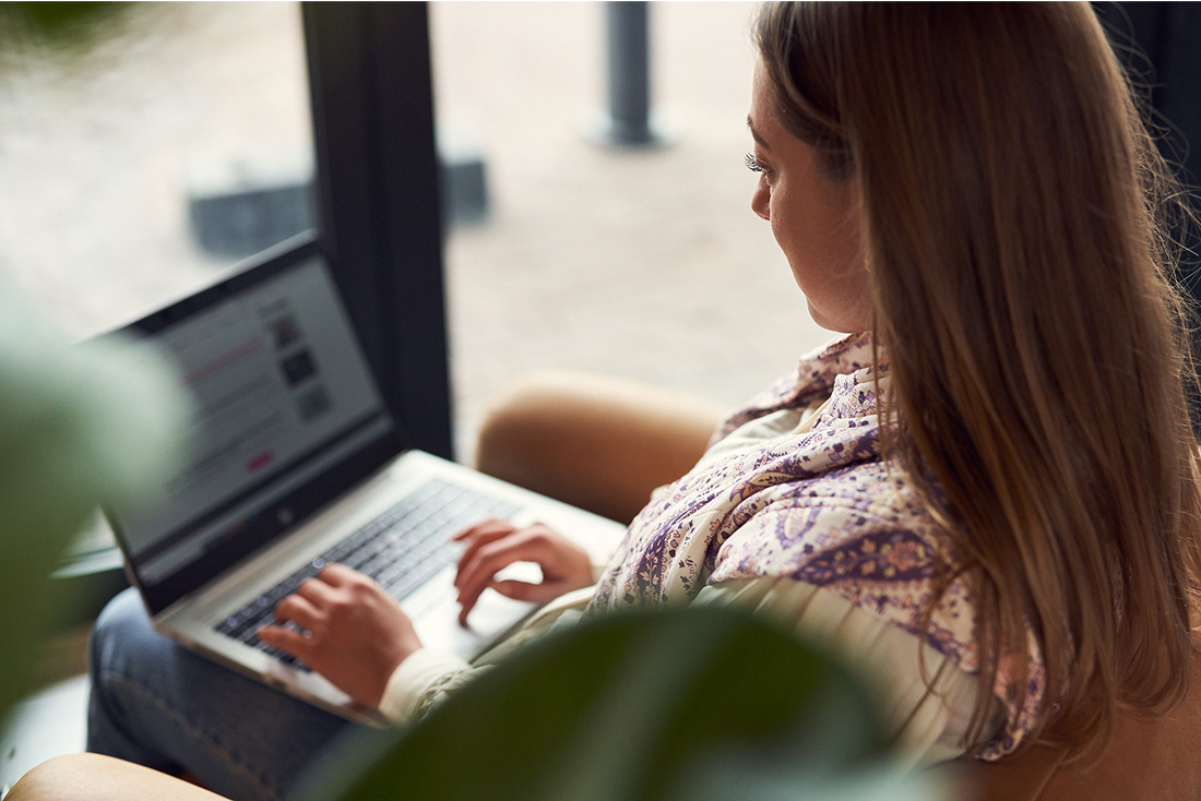 Woman working on laptop in comfortable office environment