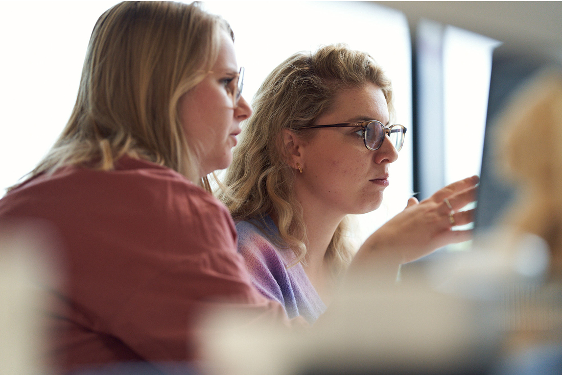 Team members engaged in focused discussion during meeting