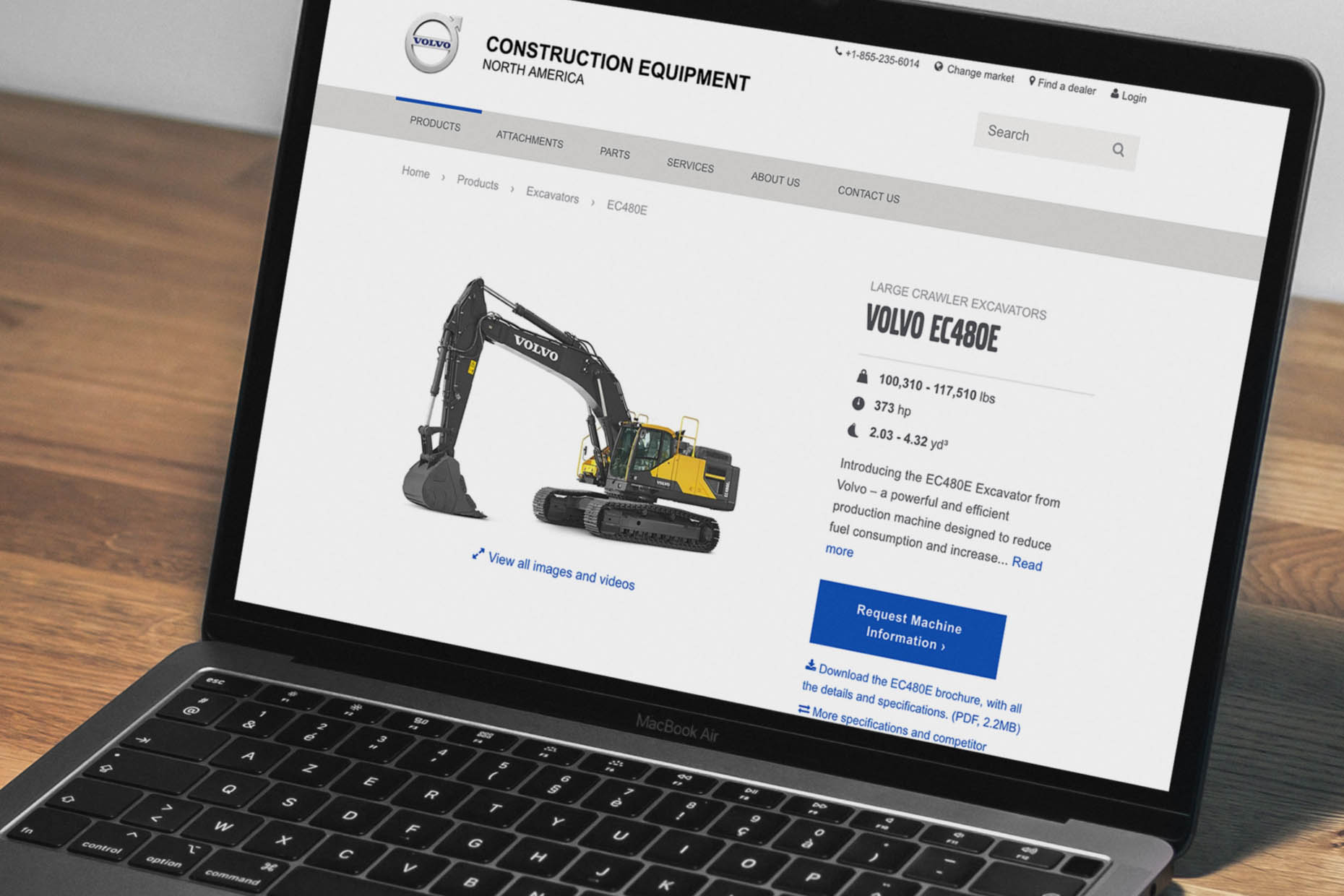 Laptop screen displaying the Volvo EC480E excavator webpage with specifications and features listed.